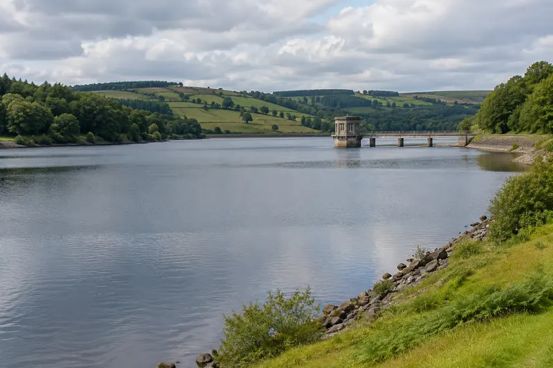 Reservoir with green banks and a small intake structure.